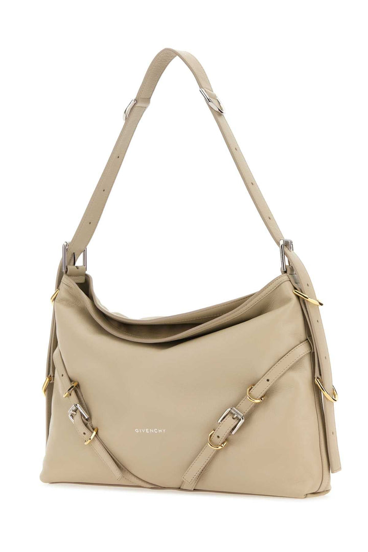 Beige handbag with gold accents on a white background