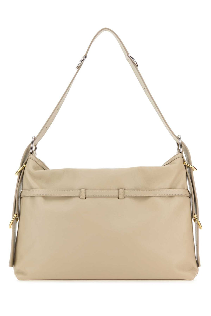 Beige handbag with a shoulder strap on a white background