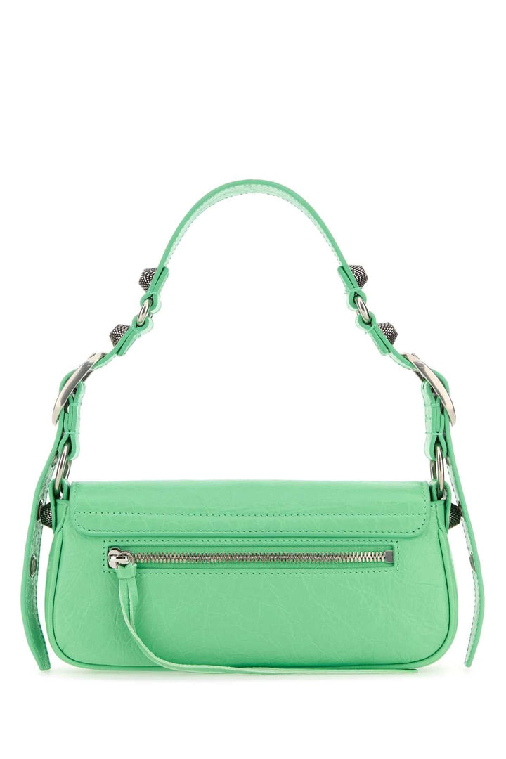Green handbag with a chain strap on a white background