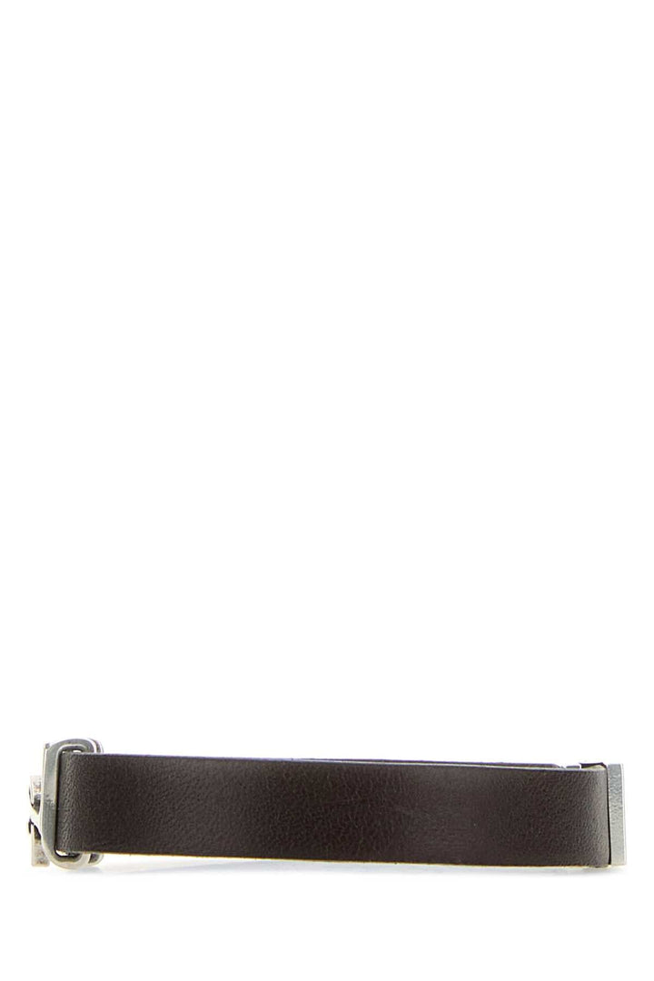 Black leather belt with silver buckle on a white background