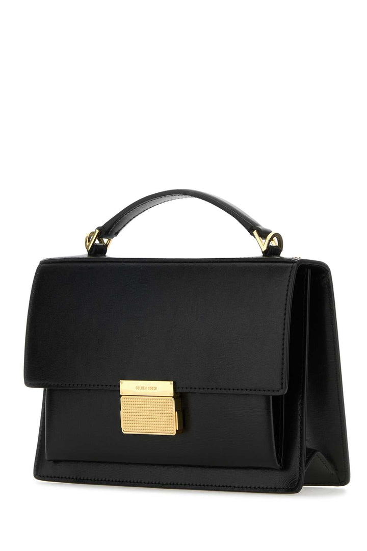 Black handbag with gold accents on a white background