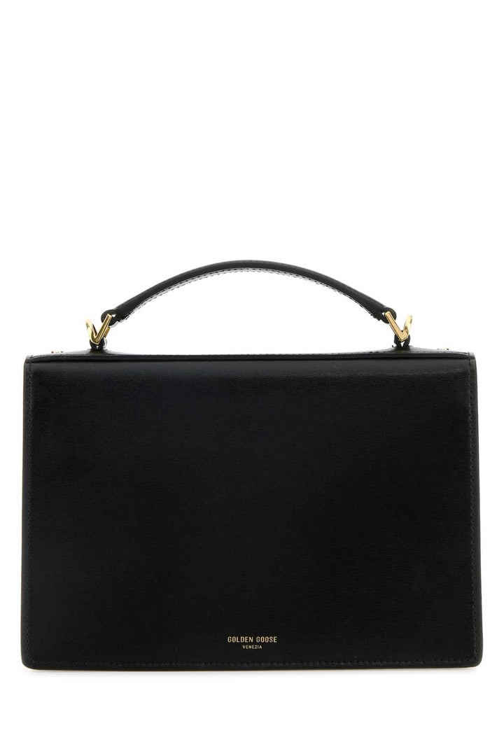 Black handbag with gold accents on a white background