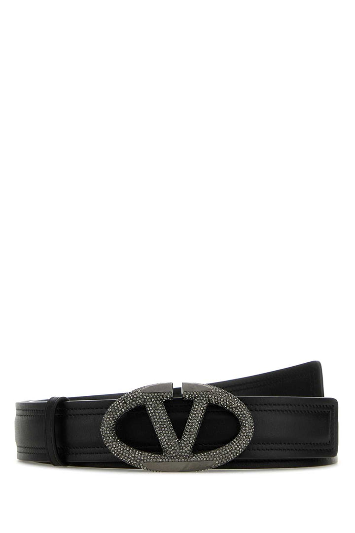Black belt with a decorative clasp on a white background