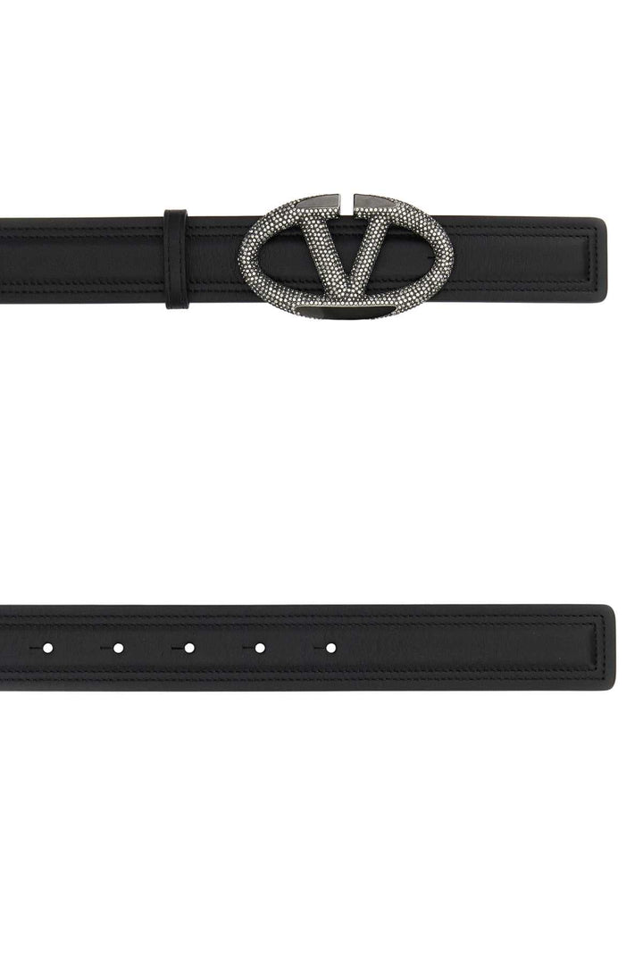 Black belt with a decorative clasp on a white background