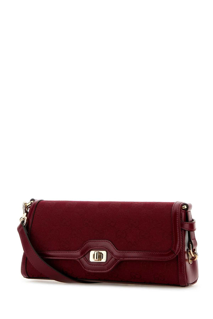 Red handbag with gold accents on a white background