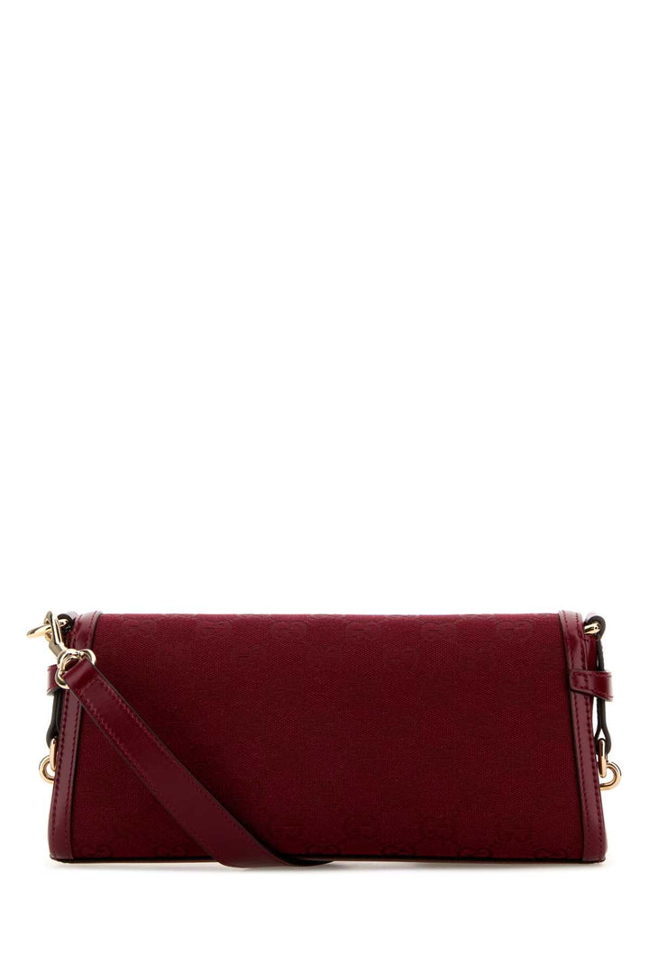 Red handbag with gold accents on a white background