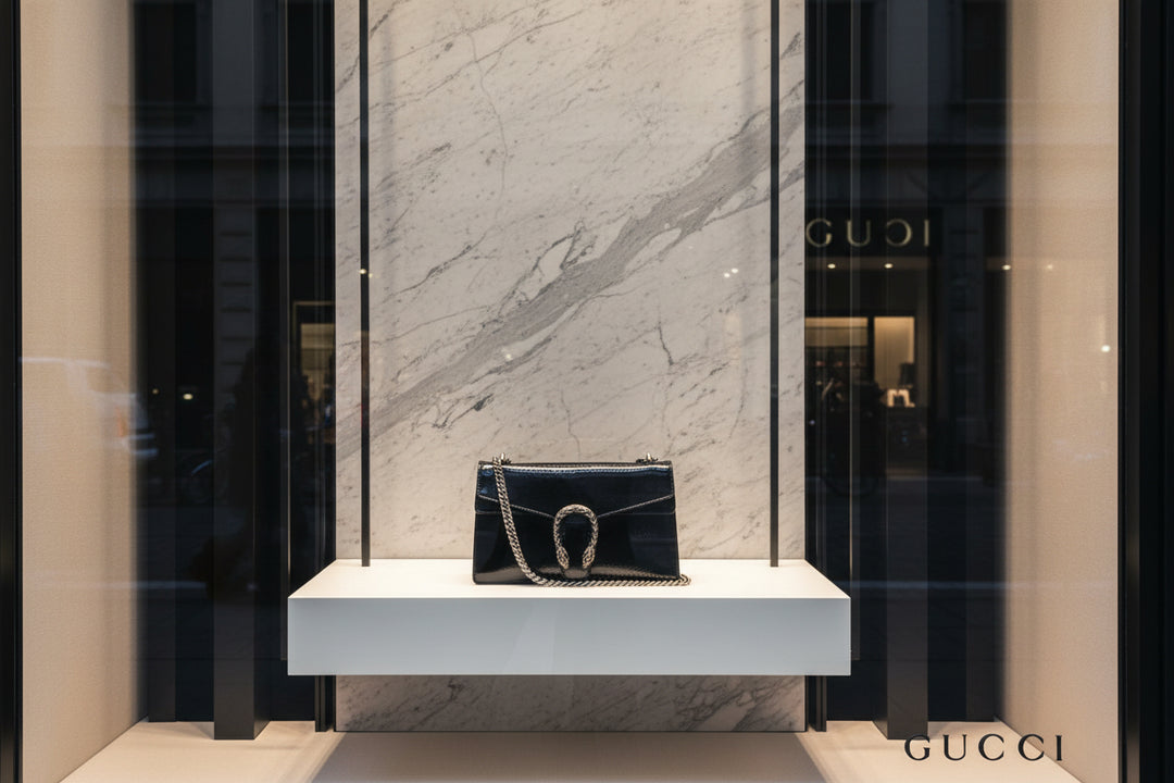 Black handbag with chain detail on a white background