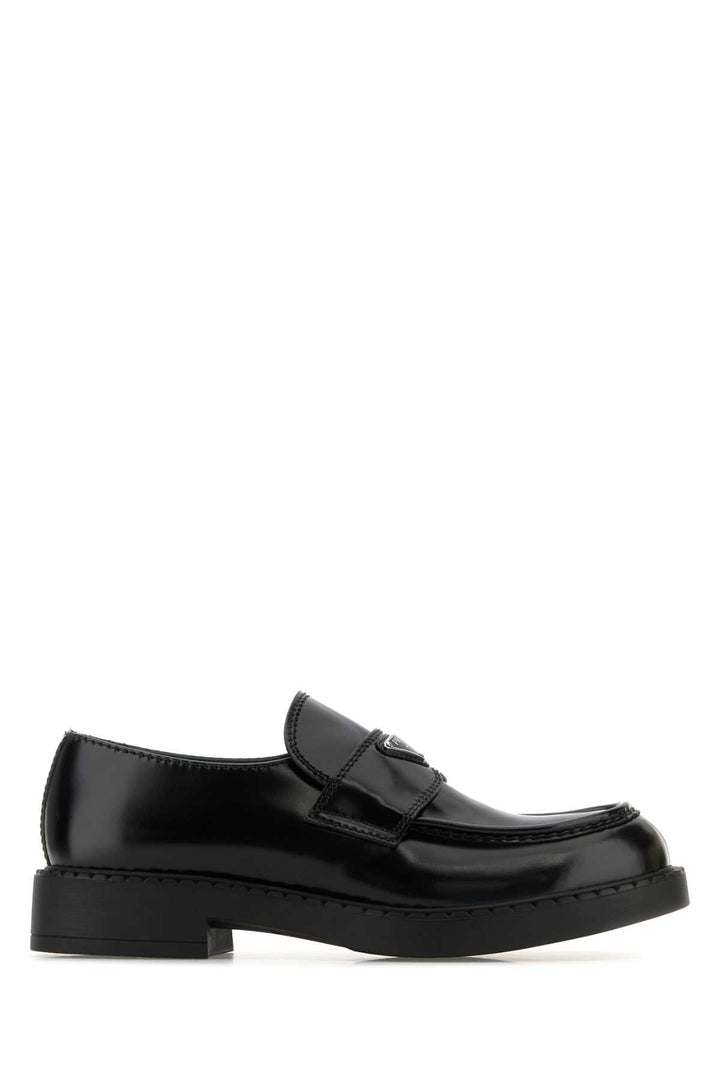 Black loafers on a white background