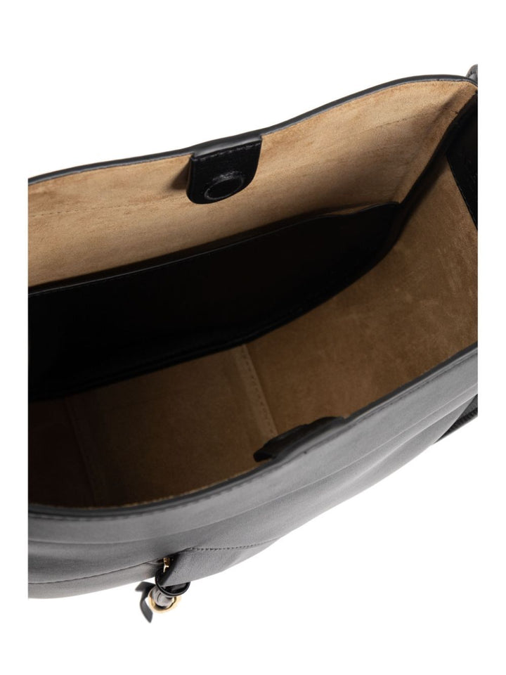 Open handbag showing interior with a neutral color scheme