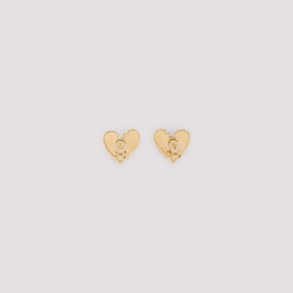 Gold heart-shaped earrings on a light gray background