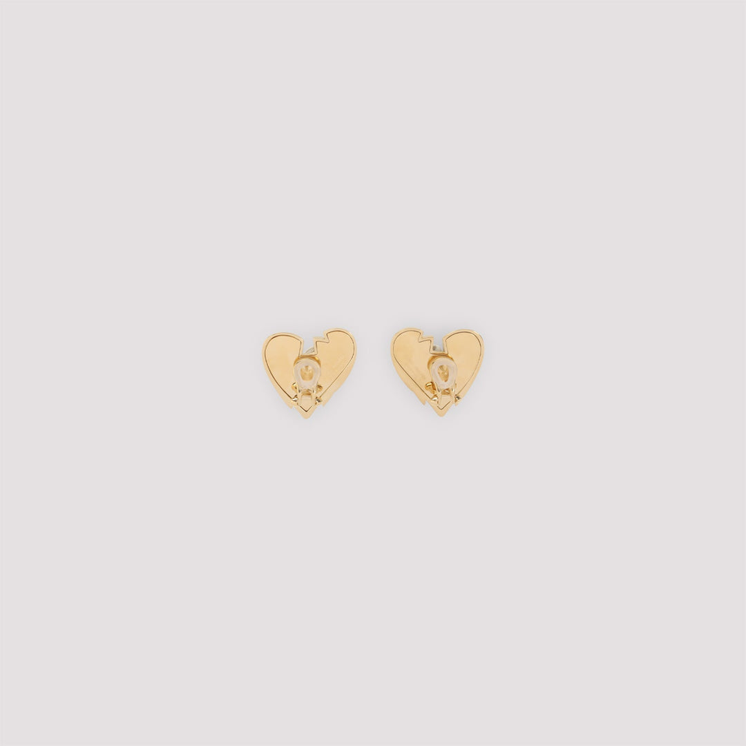 Gold heart-shaped earrings on a light gray background