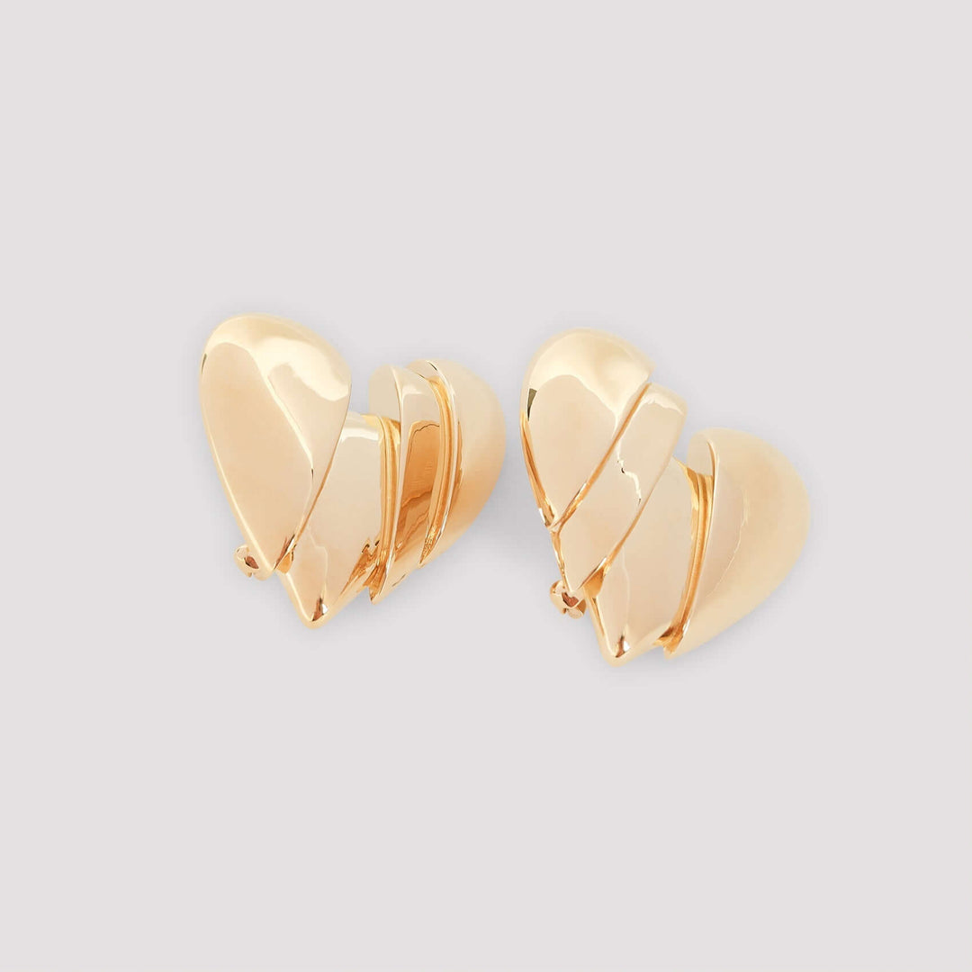 Gold heart-shaped earrings on a light gray background