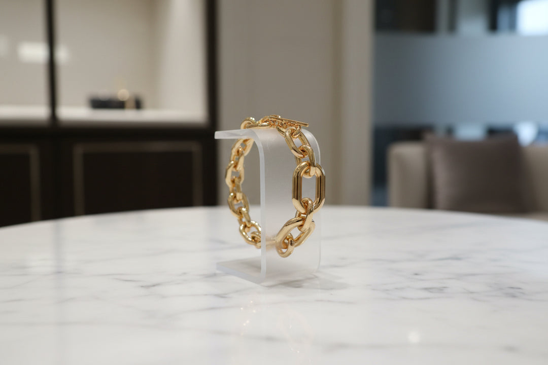 Gold chain bracelet on a white background