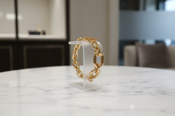 Gold chain bracelet on a white background