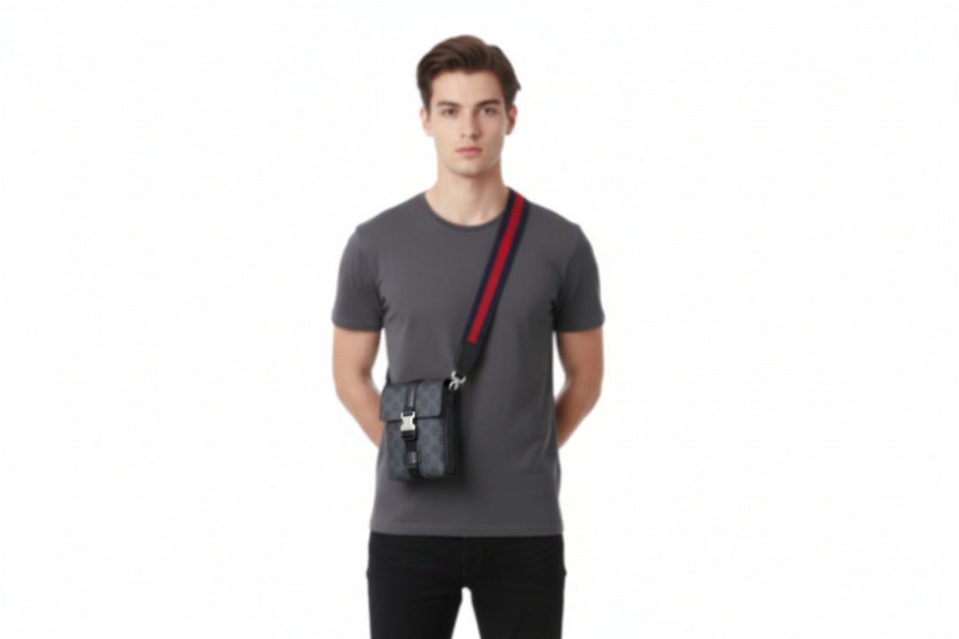 Black patterned bag with red and blue strap on a white background