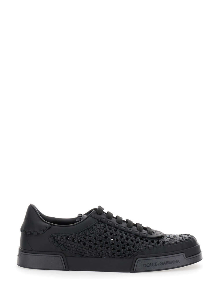 Black sneaker with detailed sole on a white background