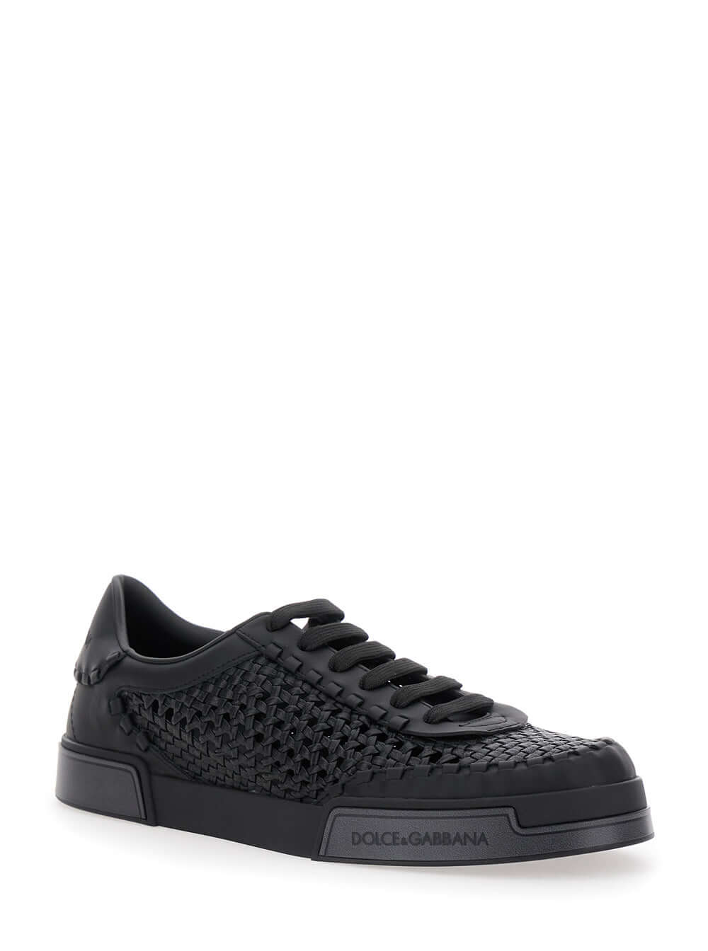Black sneaker with woven pattern on a white background