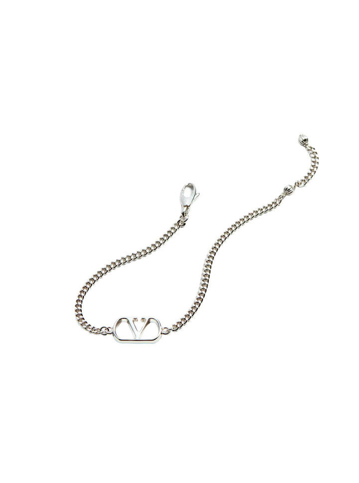 Silver bracelet with a heart-shaped clasp on a white background