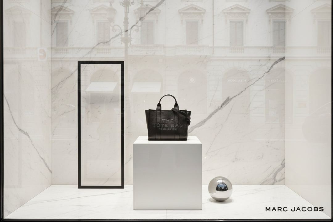 Black tote bag with 'Marc Jacobs' branding on a white background