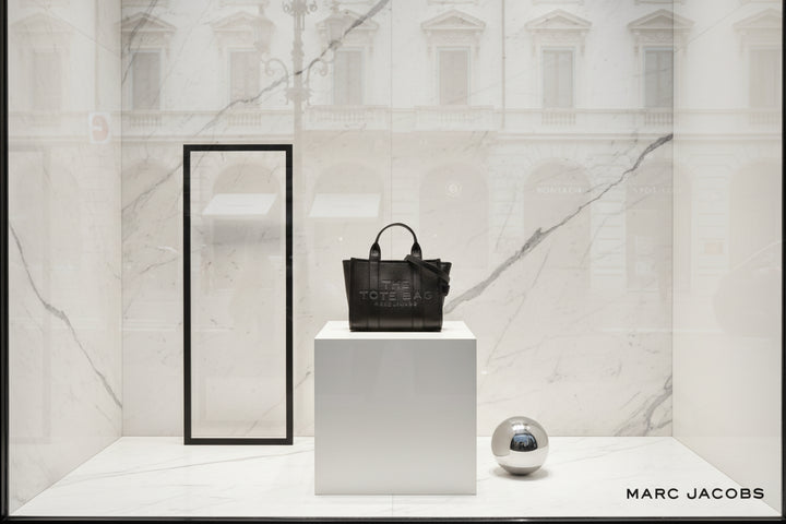 Black tote bag with 'Marc Jacobs' branding on a white background