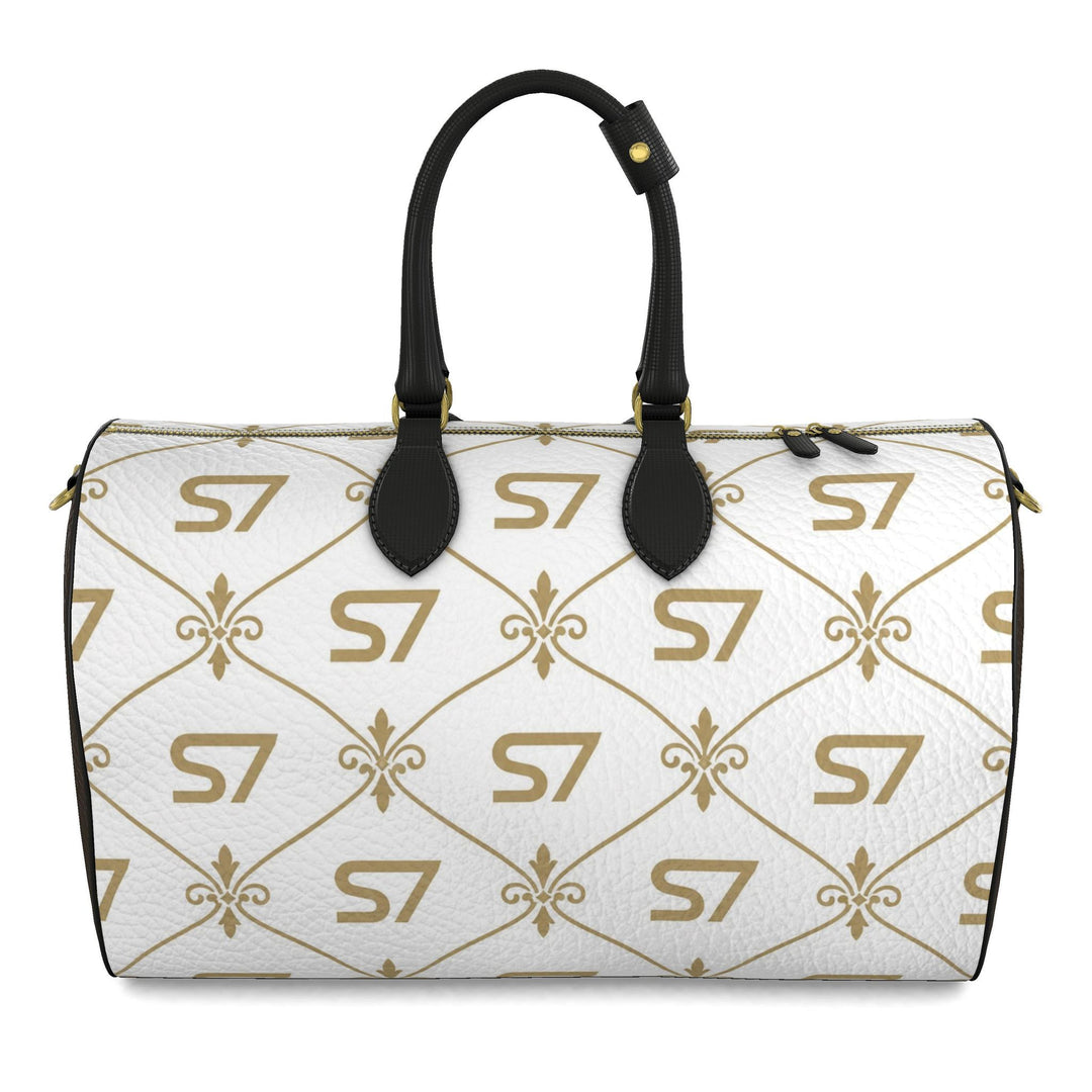 S7 Champagne Royale duffle bag with a white body, champagne-gold S7 monograms and ornate lattice, chocolate-brown sides, and black handles.
