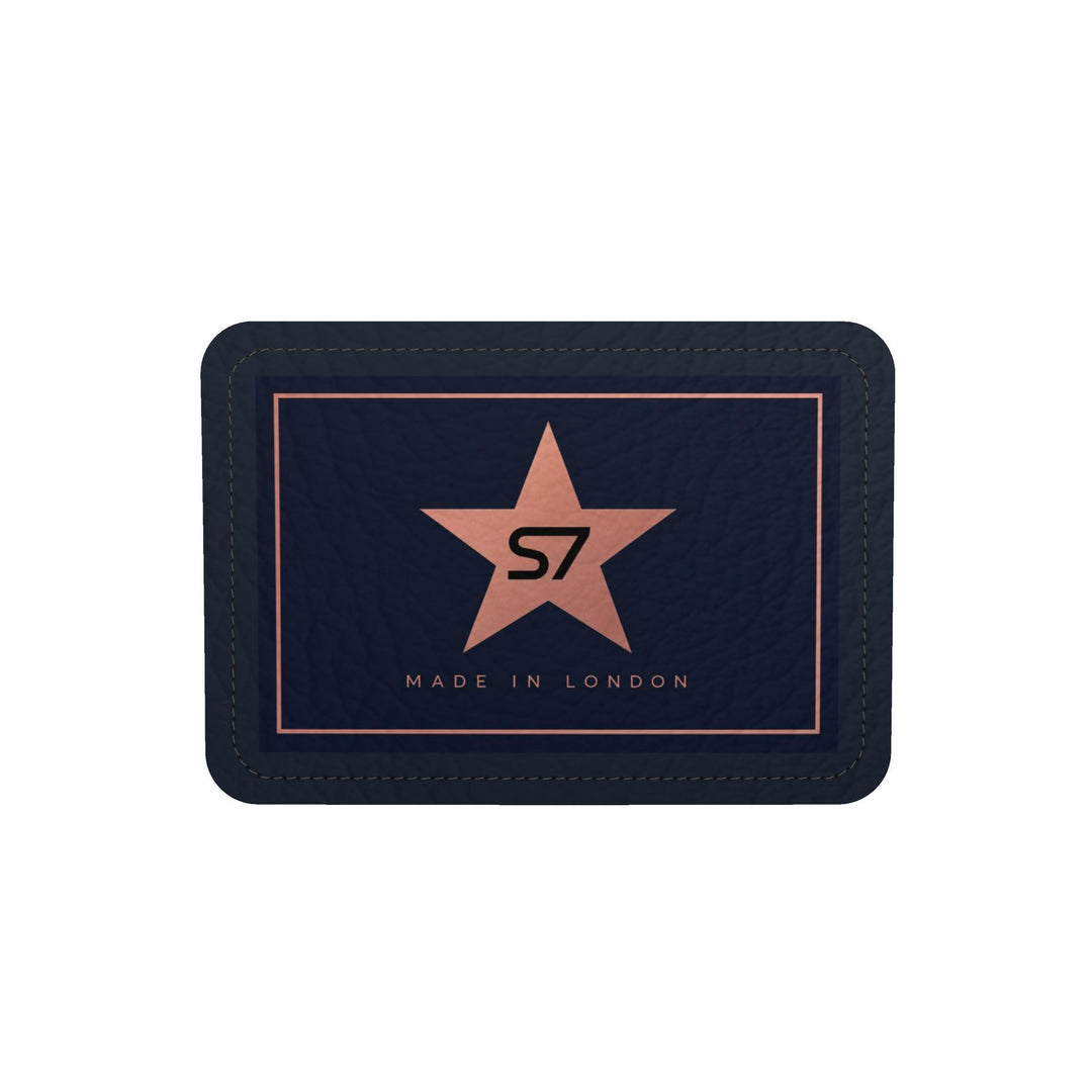 A dark navy blue leather wallet with a central rose gold star logo containing the letters &