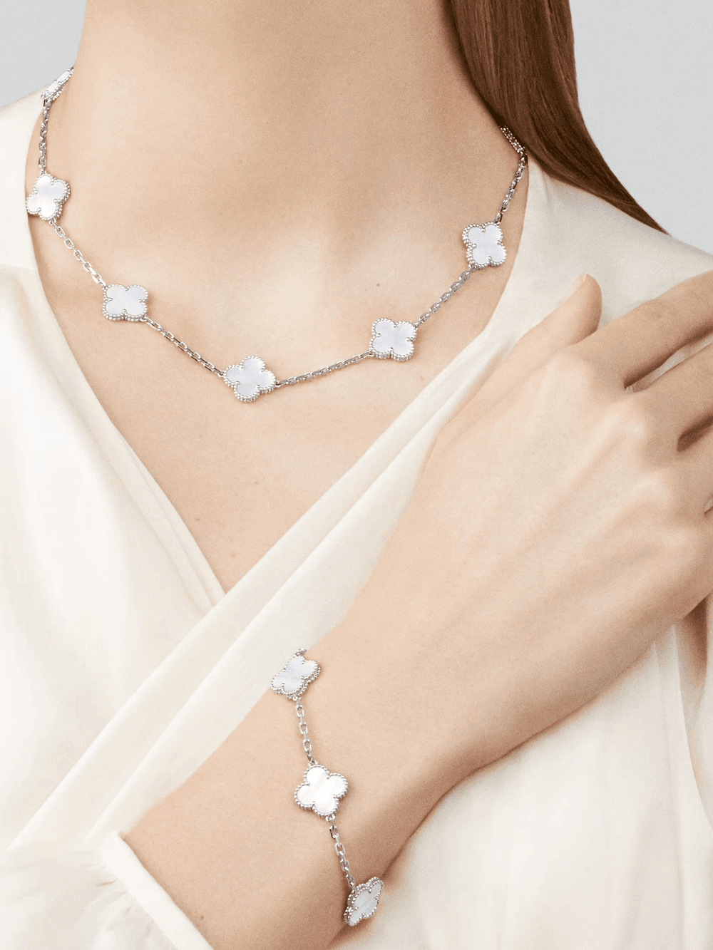 Van Cleef & Arpels Vintage Alhambra bracelet, 5 motifs 18K white gold, Mother-of-pearl worn alongside matching necklace.