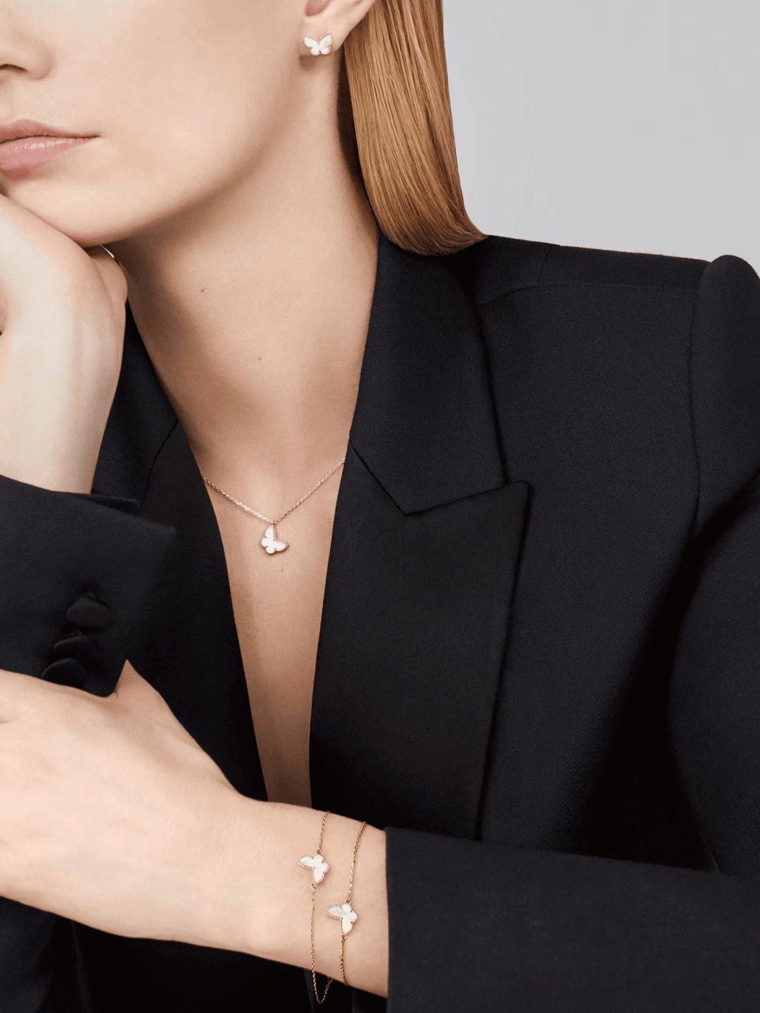 Van Cleef & Arpels Sweet Butterflies bracelet 18K yellow gold, Mother-of-pearl worn with elegant blazer.
