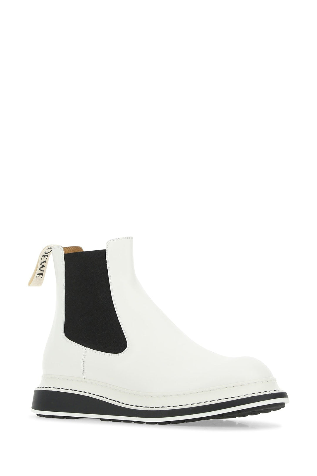 White Chelsea boot with black sole on a white background