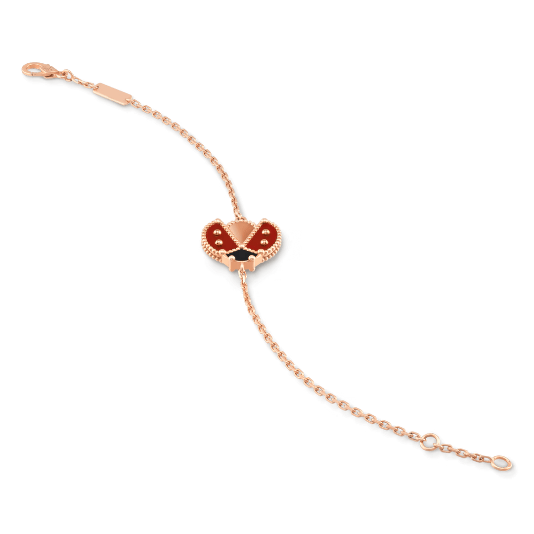 Van Cleef & Arpels Lucky Spring bracelet, open wings ladybug 18K rose gold, Carnelian, Onyx on display.