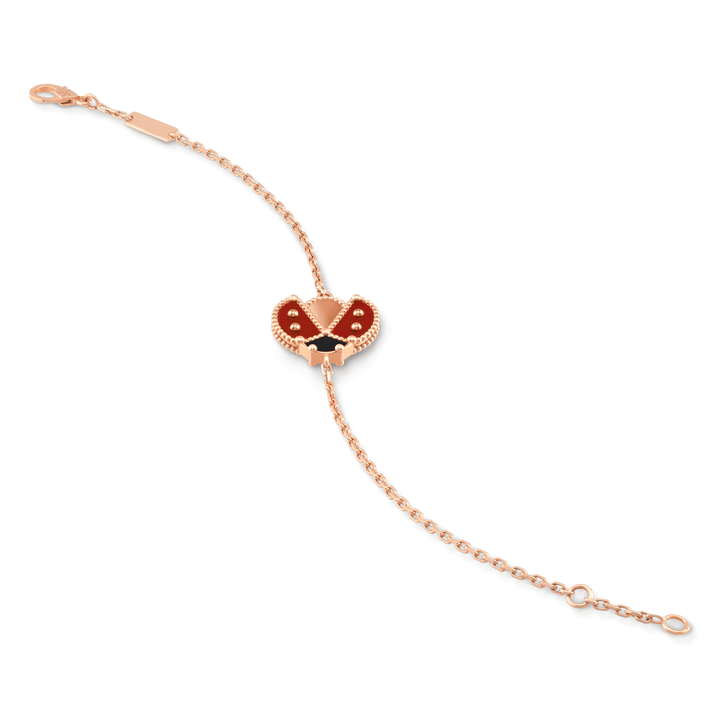 Van Cleef & Arpels Lucky Spring bracelet, open wings ladybug 18K rose gold, Carnelian, Onyx on display.