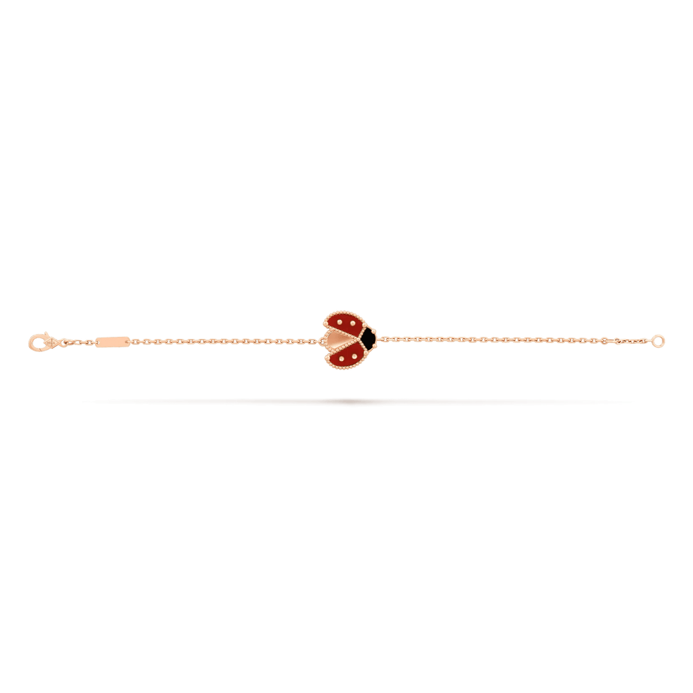 Van Cleef & Arpels Lucky Spring bracelet, open wings ladybug 18K rose gold, Carnelian, Onyx on display.