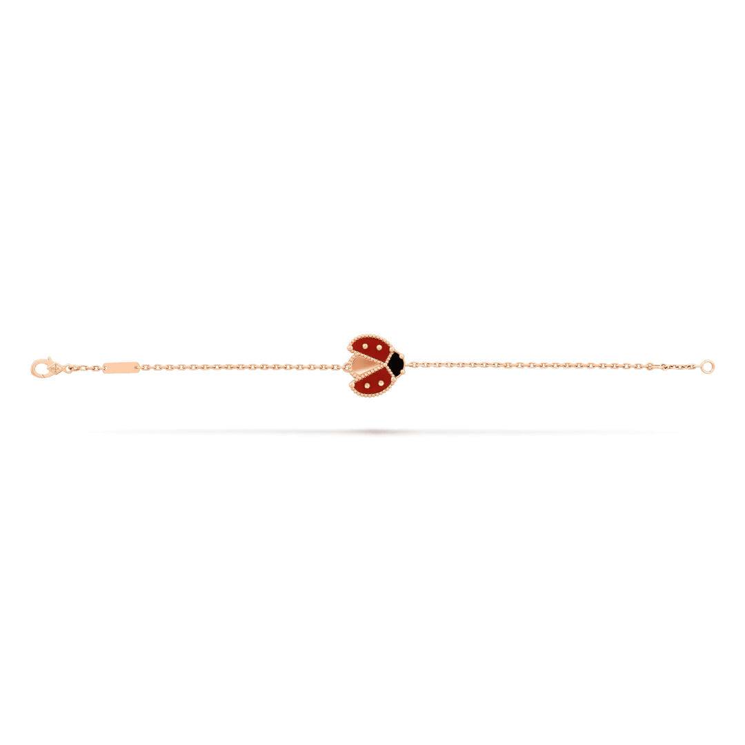 Van Cleef & Arpels Lucky Spring bracelet, open wings ladybug 18K rose gold, Carnelian, Onyx on display.