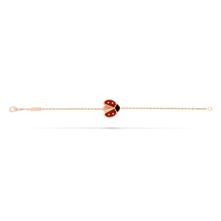 Van Cleef & Arpels Lucky Spring bracelet, open wings ladybug 18K rose gold, Carnelian, Onyx on display.