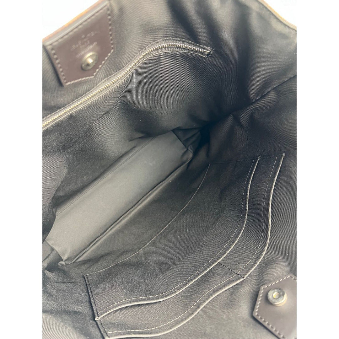 Close-up of a dark gray leather bag with stitching details