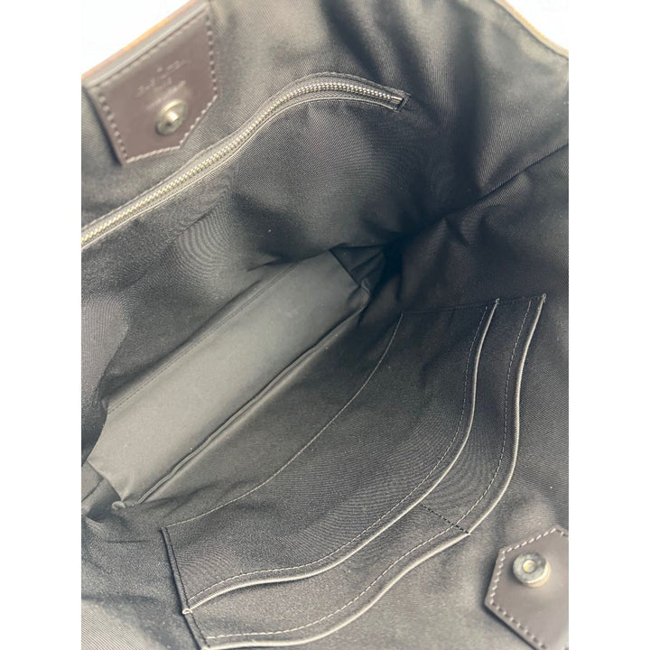 Close-up of a dark gray leather bag with stitching details