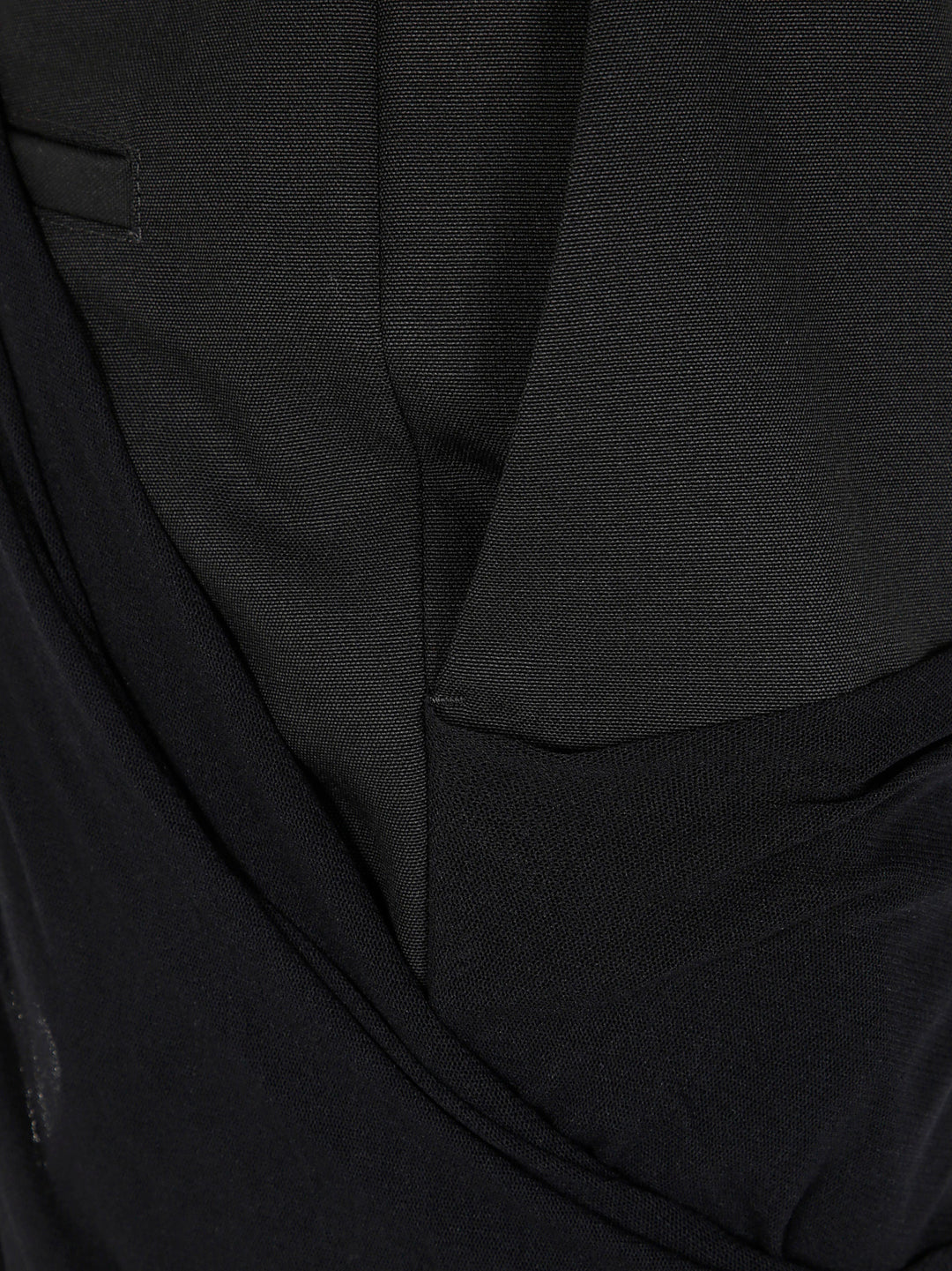 Close-up of a black suit jacket with a pocket detail