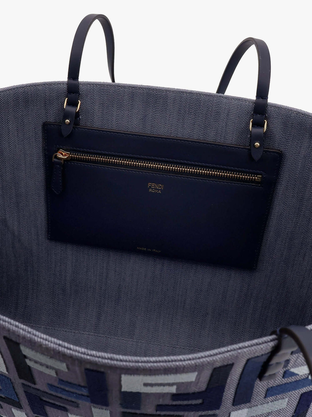 Gray tote bag with a black compartment and gold zipper, featuring the brand 'Fendi'.