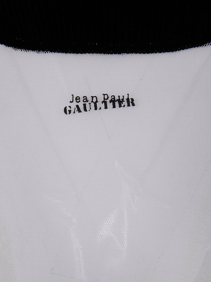 Close-up of a garment with 'Jean Paul Gaultier' branding on a white background.