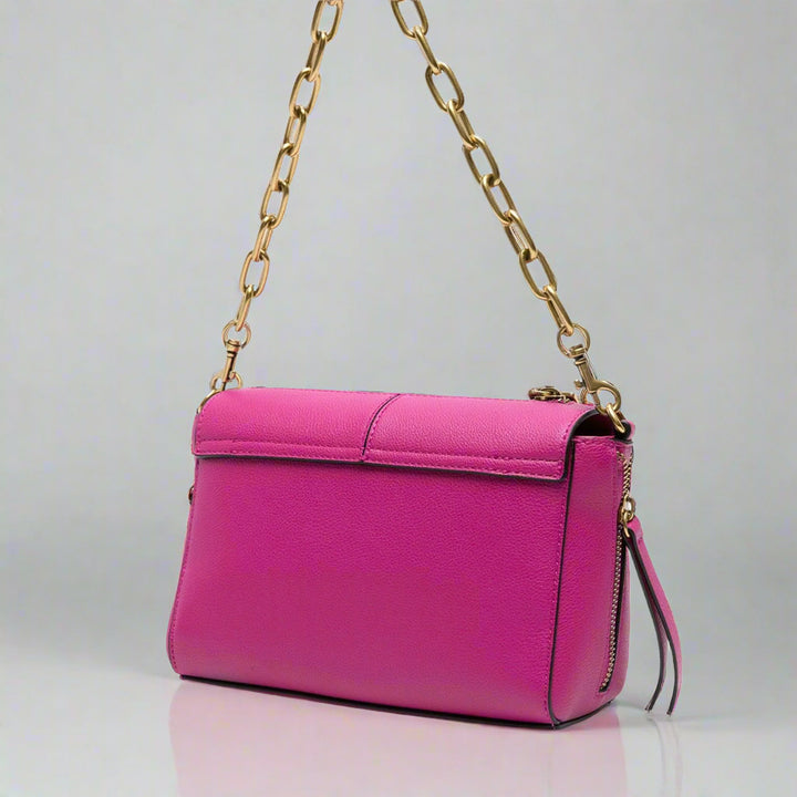 Versace Jeans Couture shoulder bag in vibrant pink with gold chain strap and logo, perfect synthetic leather handbag.