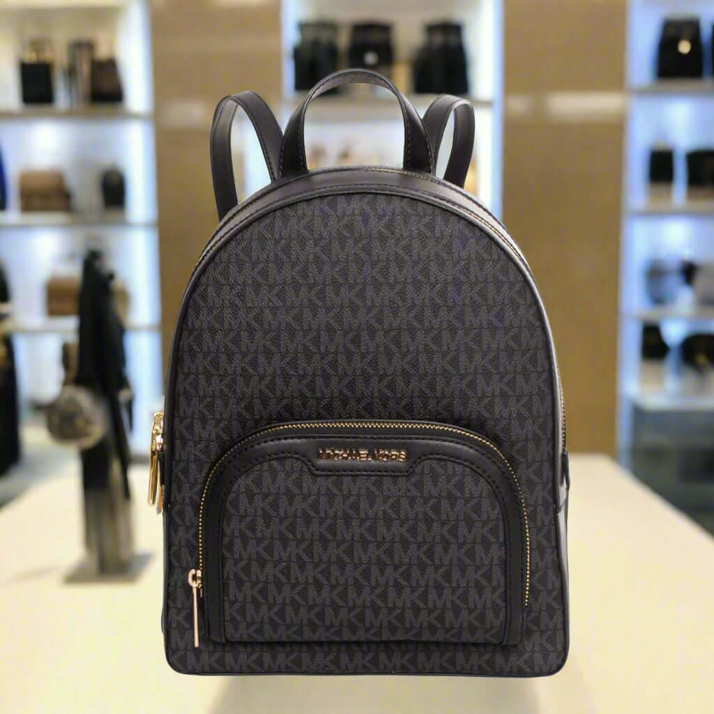 Black backpack with gold accents on a white background