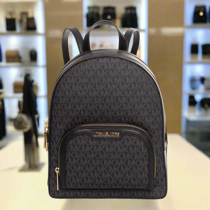 Black backpack with gold accents on a white background
