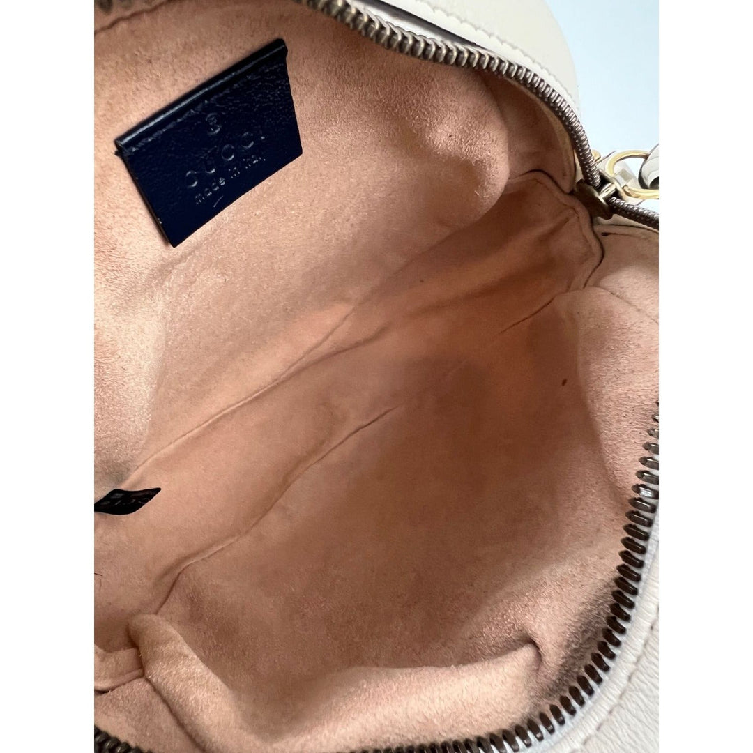 Close-up of a beige leather bag with a visible brand label.