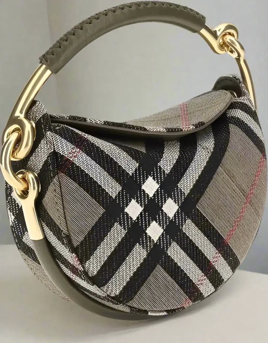 Plaid patterned handbag with gold handle on a white background