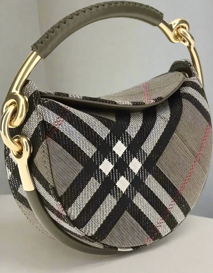 Plaid patterned handbag with gold handle on a white background
