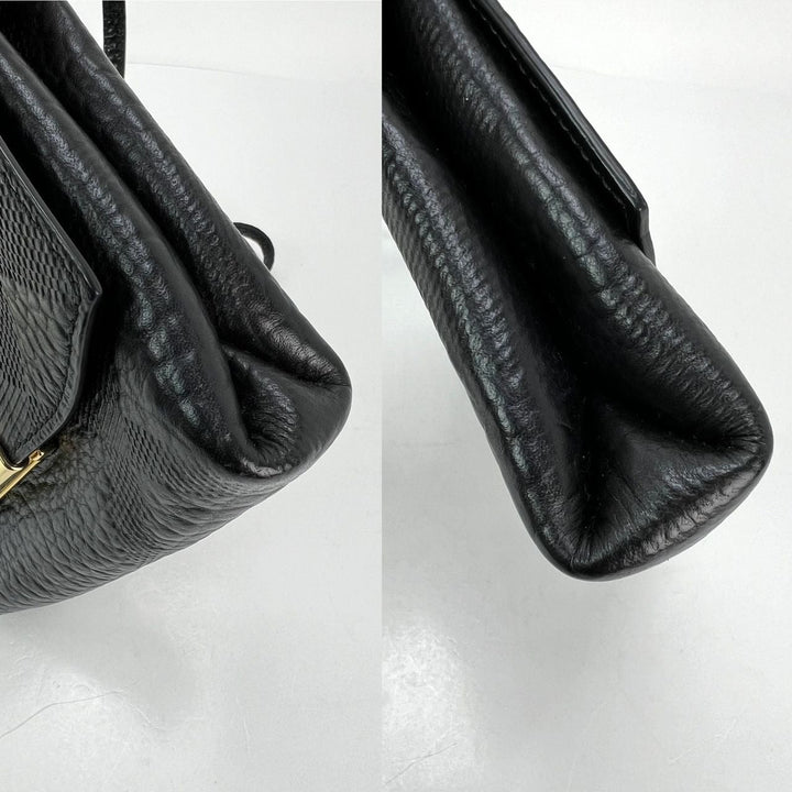 Close-up of a black textured handbag on a white background