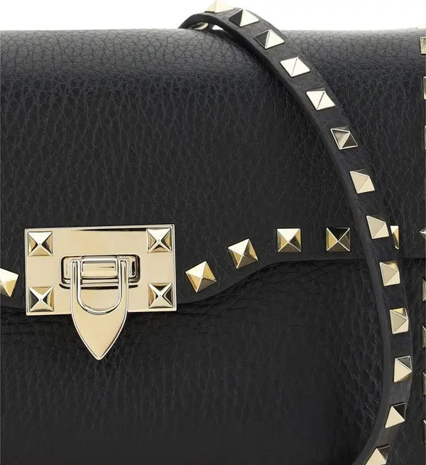 Valentino Garavani women's designer handbag in leather Luxury Valentino Garavani shoulder bag with iconic studs Valentino Garavani crossbody bag in black with gold accents