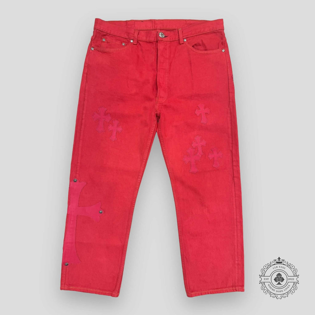 Red jeans with pink floral patterns on a gray background