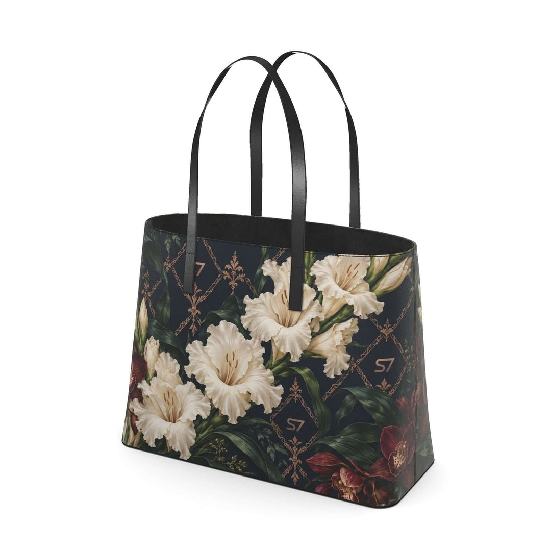 S7 Midnight Conservatory leather tote with ivory gladiolus, burgundy orchids and rose-gold monogram lattice on midnight navy.