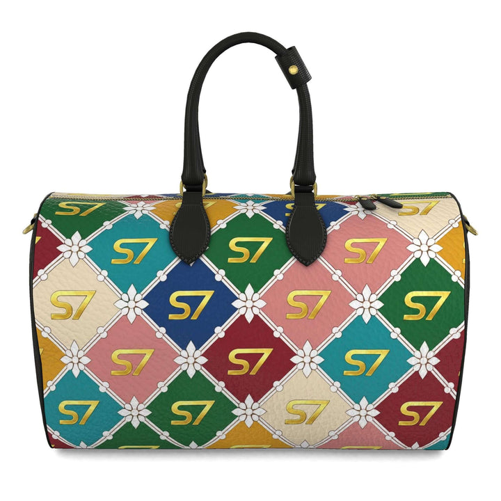 S7 Harlequin Royale leather duffle with yellow-gold S7 monograms, white floral diamond lattice, multicolor panels, black handles, and gold-tone hardware.